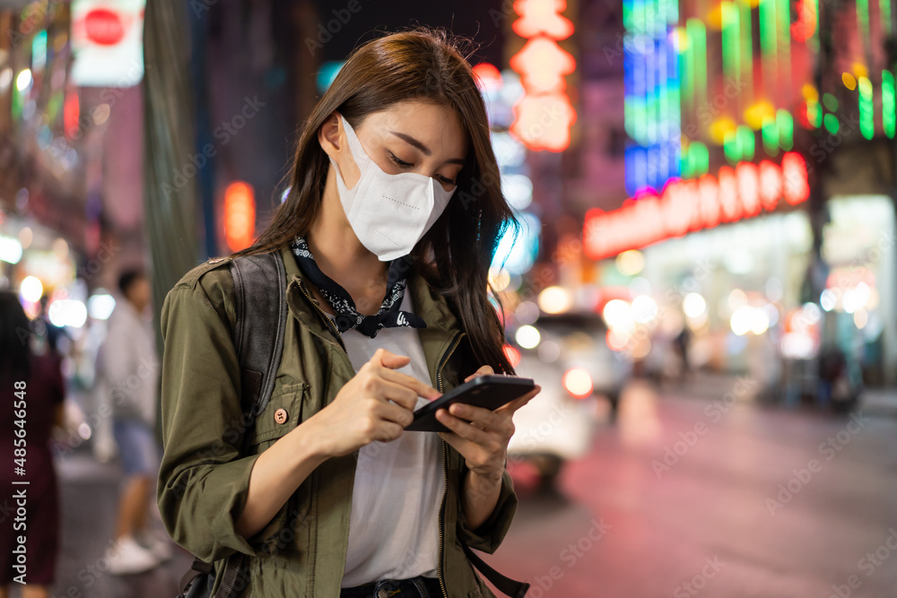 Asian attractive woman backpacker chatting on phone while walk in city. Asian attractive woman backpacker chatting on phone while walk in city.