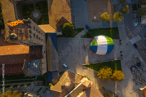 Aerial view of a hot ai balloon in Monestir square near Santa Maria de Ripoll monastery in Girona, Spain. photo