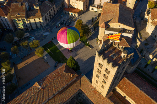 Aerial view of a hot ai balloon in Monestir square near Santa Maria de Ripoll monastery in Girona, Spain. photo