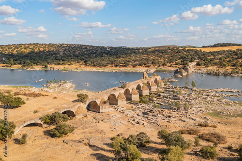 Aerial view of Puente Ayuda, a collapsed stone bridge crossing the Guadiana river, Spain.