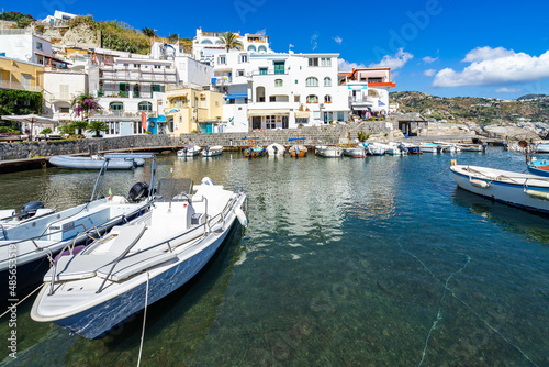 Fishing boats moored at the colorful port of Sant’Angelo d’Ischia, Italy
