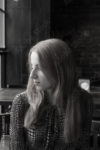 Beautiful girl in a cafe. Black and white photo