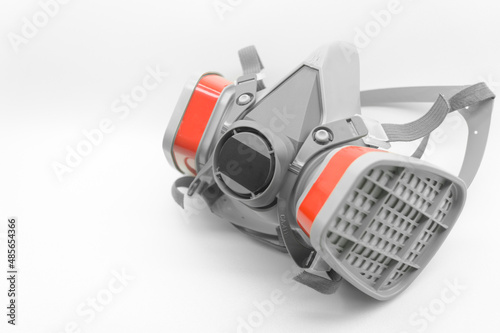 Respirator. Gas mask. Filter mask to protect the respiratory system from dust and polluted air. Protective workwear. Selective focus, Isolated on white