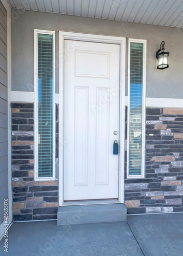 Vertical Facade of a front door with two side panels and window