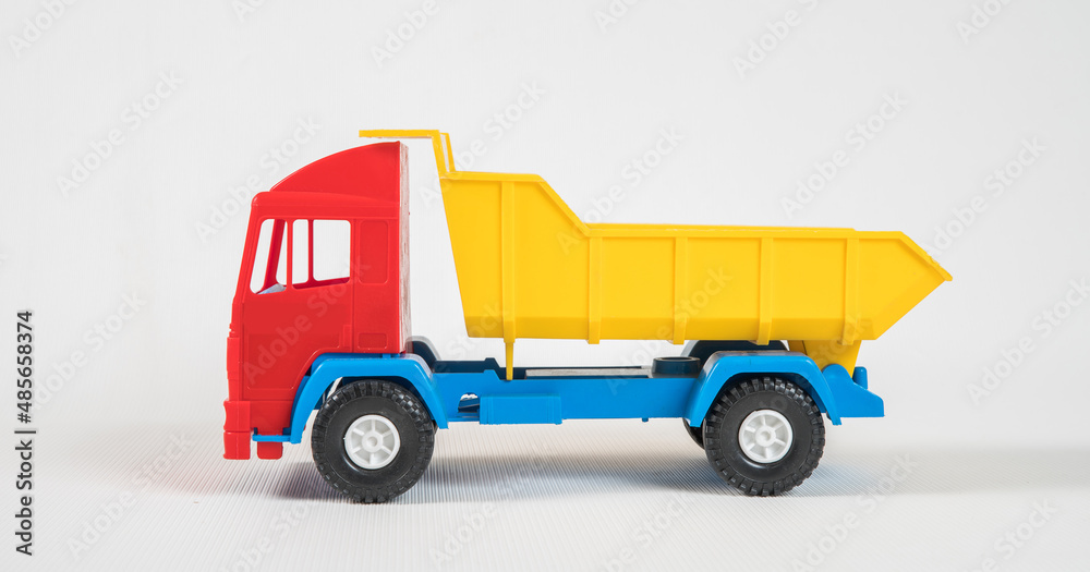 Truck. Plastic toy multicolored cars isolated on white background.