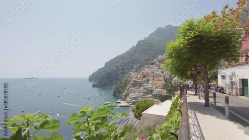 A panoramic view of the Positano on the Amalfi Coast, Italy. Sunny day, coastline, cliff, sea, boats, beautiful day, scenic, Italian architecture, gimbal camera move - 4K Video Footage