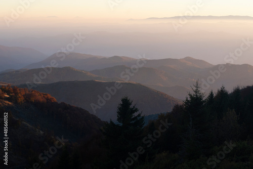 Autumn scenery of foggy Serbian mountain range at early morning sunrise.