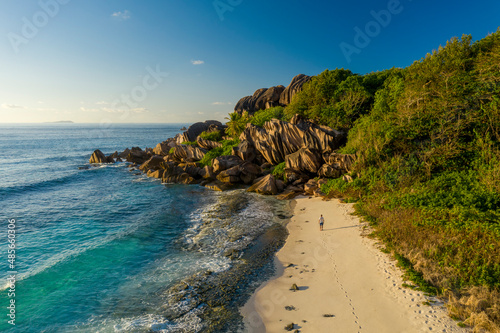 Aerial view of a person walking on the beach at Grand Anse, La Digue and Inner Islands, Seychelles. photo