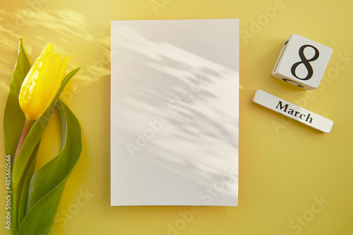 Feminine post card mock up with shadows, chocolate hearts, text 8 of March with yellow tulip. Women's Day, happy birthday, anniversary concept. Beauty mockup postcard concept. Copy space. photo