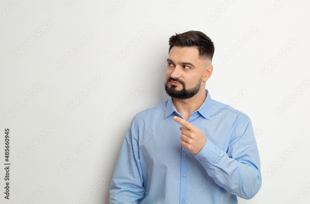 Portrait of a man pointing his finger showing copy space on a white background. Portrait of a man pointing his finger showing copy space on a white background.