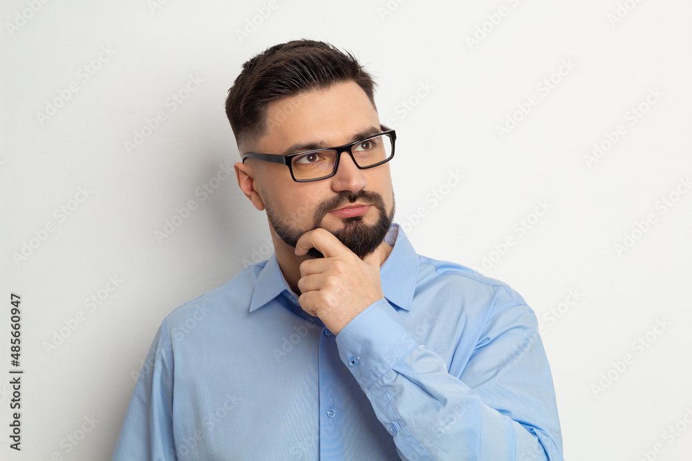 Portrait of a thinking business man with a beard on a white background. Pensive about the idea of a male. Portrait of a thinking business man with a beard on a white background. Pensive about the idea of a male.
