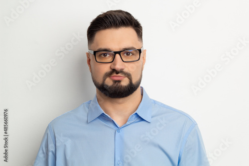 Portrait of a handsome business man in glasses with a beard on a white background. © Oleksandr