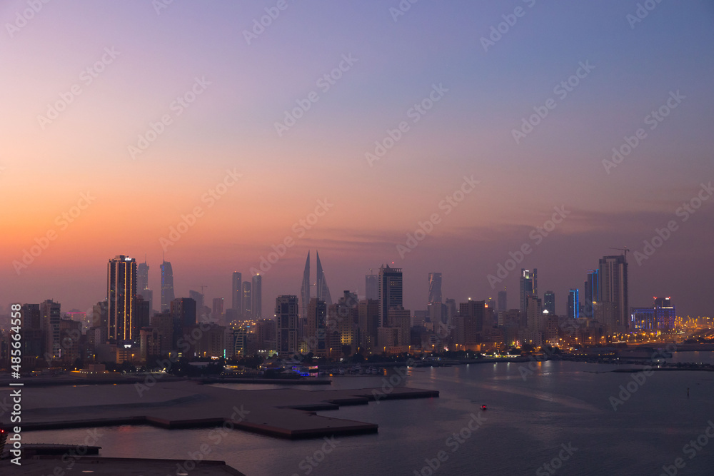 Manama city skyline at sunset in the Gulf country of Bahrain 