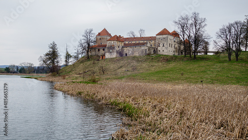 Beautiful panorama of Svirzh castle by the river on a spring day, near Lviv
