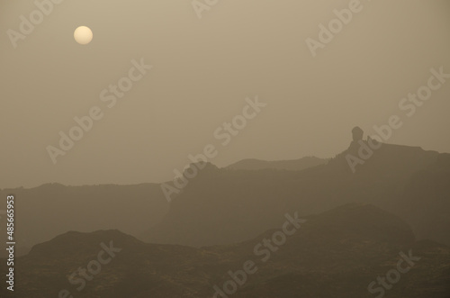 Roque Nublo at dawn on a day of airbone dust. The Nublo Rural Park. Tejeda. Gran Canaria. Canary Islands. Spain. photo