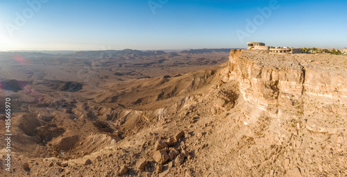 Panoramic aerial view of Ramon visitor center and Makhtesh Ramon at sunrise, Mizpe Ramon, Negev, Israel.
