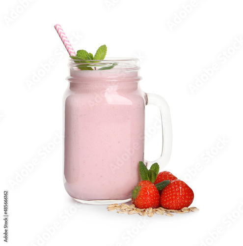 Mason jar of tasty strawberry smoothie with oatmeal, mint and fresh berries on white background