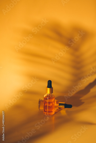 bottles with cosmetic liquid on studio background
