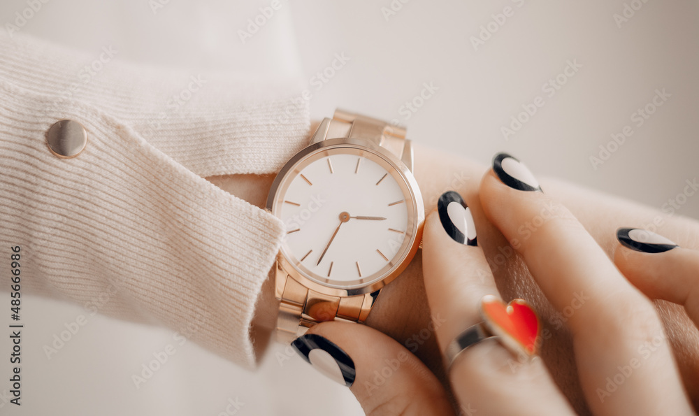 Beautiful stylish white watch on woman hand - obrazy, fototapety, plakaty 