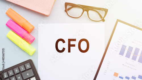 CFO, Chief Financial Officer, Text on notepad and office accessories on white desk