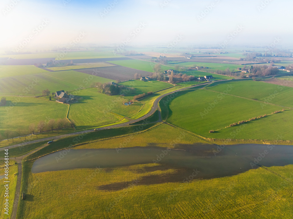 Aerial view of dike and partly flooded floodplains along the river IJssel, Welsum, Overijssel, Netherlands. Aerial view of dike and partly flooded floodplains along the river IJssel, Welsum, Overijssel, Netherlands.
