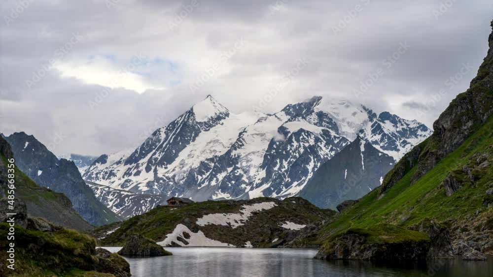 Swiss Alps water reflection in Lac de Louvie - mountain lake above Val de Bagnes valley, Switzerland. Swiss Alps water reflection in Lac de Louvie - mountain lake above Val de Bagnes valley, Switzerland.