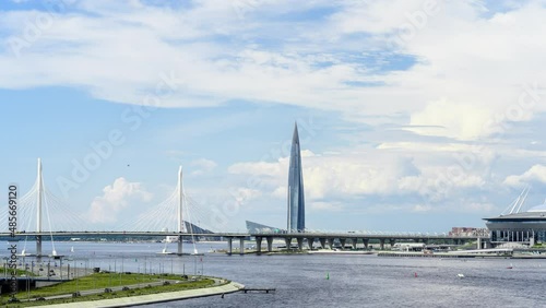 Time lapse. Top view to the moving cars on the highway above Neva river in the city of Saint Petersburg. Skyscraper Lahta center and cable-stayed bridge over the Gulf of Finland are on the background photo