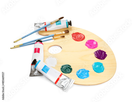 Wooden artist's palette with brushes and paints on white background