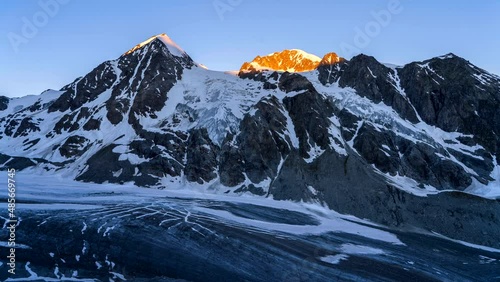 Time lapse shot of sunrise in Swiss Alps near a Glacier de Corbassiere, Switzerland. photo