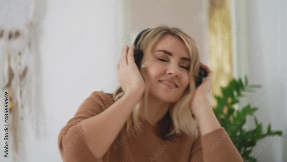 Close up portrait of young happy woman in headphone dancing at home in bright room Video hd slow motion Close up portrait of young happy woman in headphone dancing at home in bright room Video hd slow motion