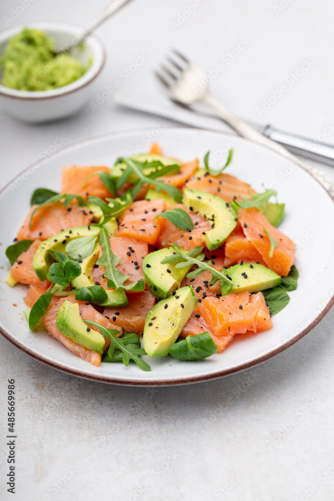Fresh salmon salad with avocado, for keto and low carb diet. Rusty background, top view, copy space. Fresh salmon salad with avocado, for keto and low carb diet. Rusty background, top view, copy space.