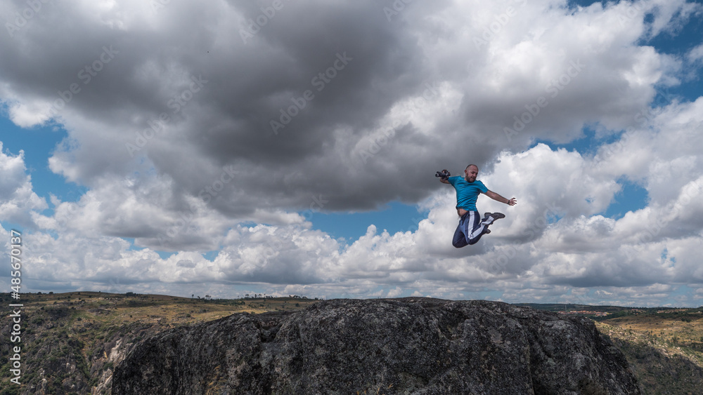 Mountains landscape with a man jumping in the air

