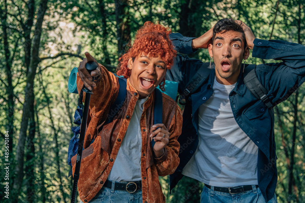 young travel couple pointing excited