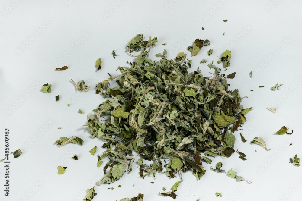 Heap of dried leaves for tea on a white background. Medicinal plants. Alternative medicine Heap of dried leaves for tea on a white background. Medicinal plants. Alternative medicine