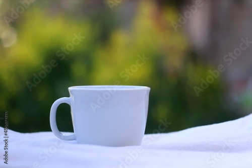 Cup of tea or coffee, served in a garden. Selective focus.