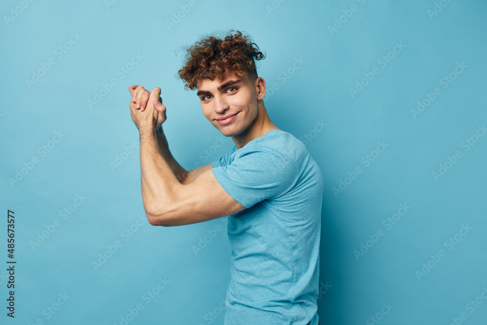 handsome guy in blue t-shirts with a pumped-up body unaltered handsome guy in blue t-shirts with a pumped-up body unaltered