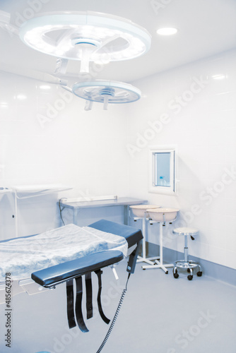 Fototapeta Naklejka Na Ścianę i Meble -  Empty interior operating room and modern equipment in hospital. Medical device for surgeon surgical emergency patient in blue tone style. Save life medical treatment concept