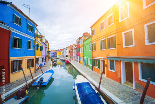 View of streets with colorful houses in Burano along canal. Typical tourist place burano island in Venetian lagoon Italy. Beautiful water canals and colorful architecture. Burano Italy 7 october 2021 © olenap