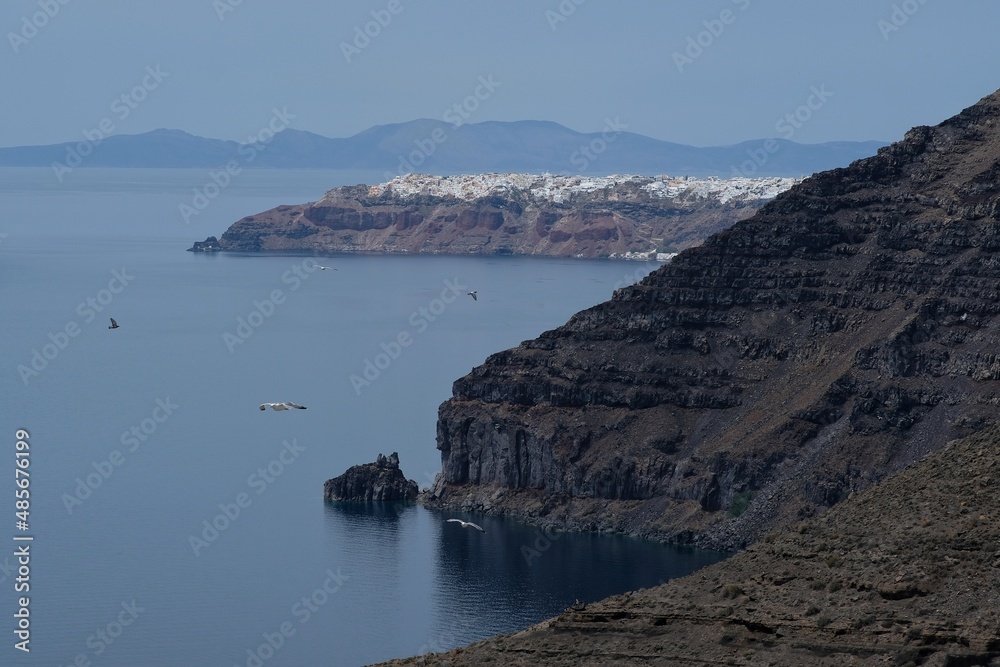 Volcanic landscape and the picturesque village of Oia in the background in Santorini Greece