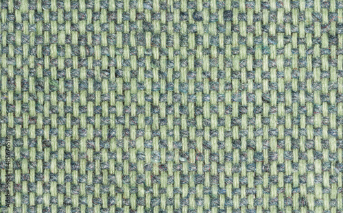 Rough synthetic fabric in green color close-up.