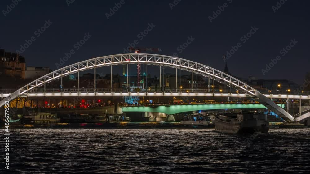 Enlightened Pedestrian Bridge at Night in Paris Seine River and Tourists Cruises Enlightened Pedestrian Bridge at Night in Paris Seine River and Tourists Cruises