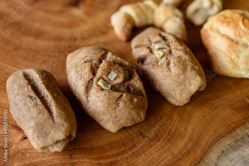 Homemade Brazilian wholemeal breads on wooden background.