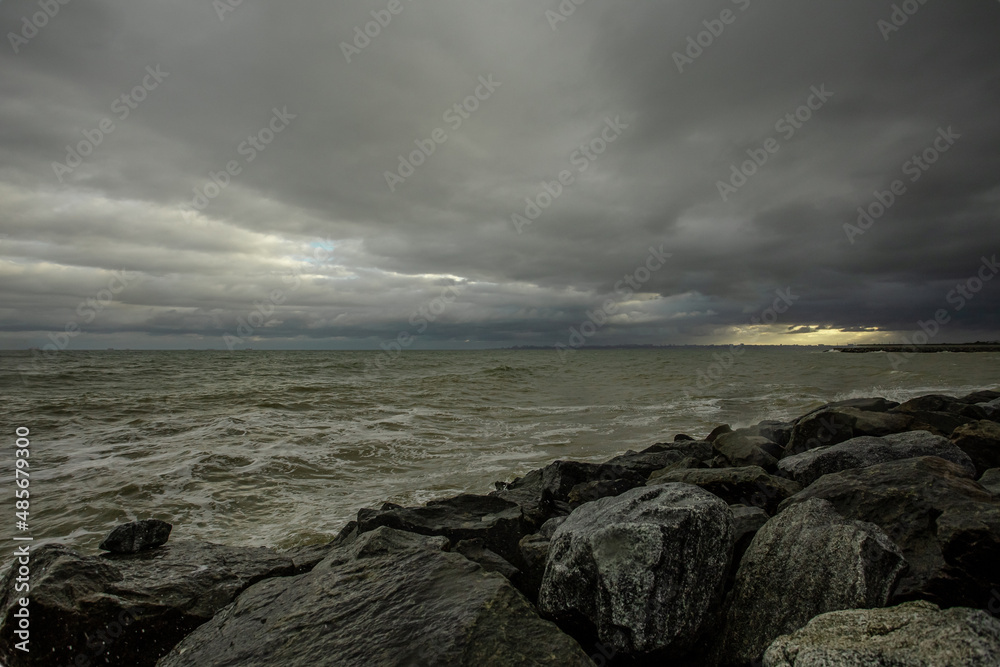 dramatic sky over the black sea with waves, clouds and stones dramatic sky over the black sea with waves, clouds and stones