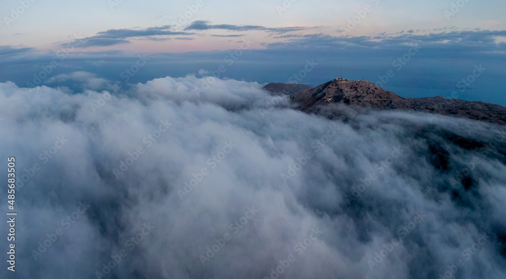 Aerial view of mount pantokrator in fog day in corfu greece