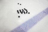 pucks on empty ice rink