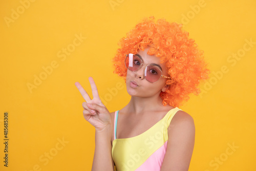having fun. child wear sunglasses and swimsuit. teen girl with orange hair. summer beach fashion.