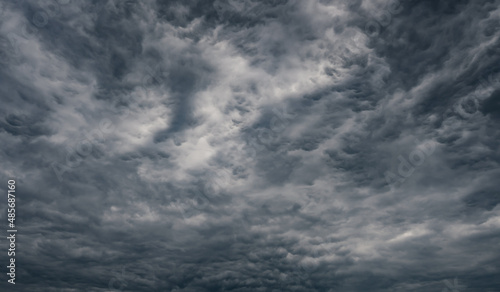 Dramatic rain storm clouds background. Light in Dark.