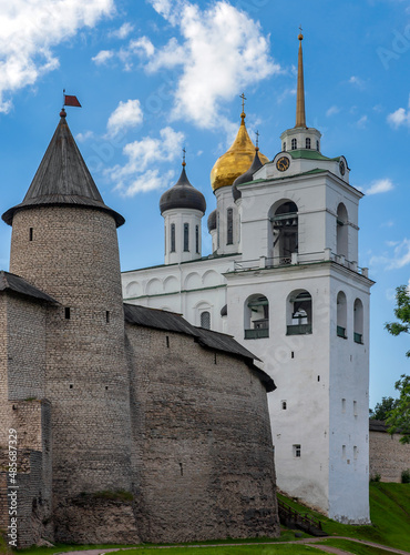 Pskov Kremlin with the domes of the Trinity Cathedral, Bell Tower and Clock Tower on the background of the summer sky.