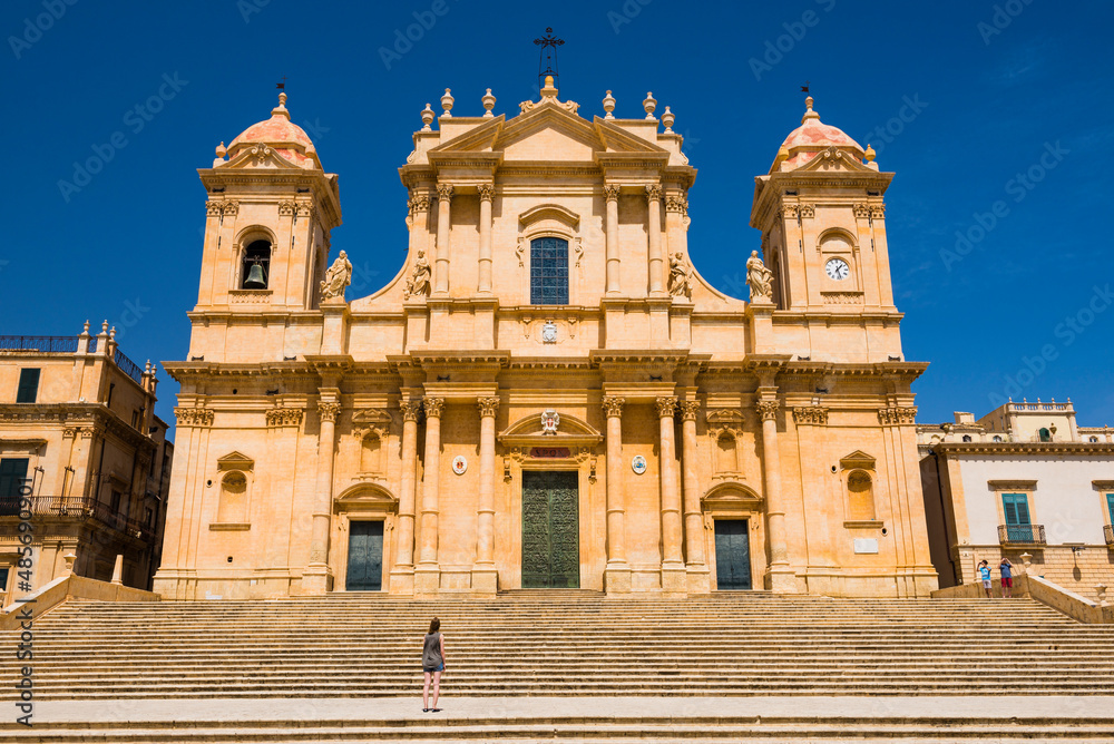 Noto, Sicily, a tourist visiting St Nicholas Cathedral (Noto Cathedral, Cattedrale di Noto), a Baroque building in Noto, Sicily, Italy, Europe