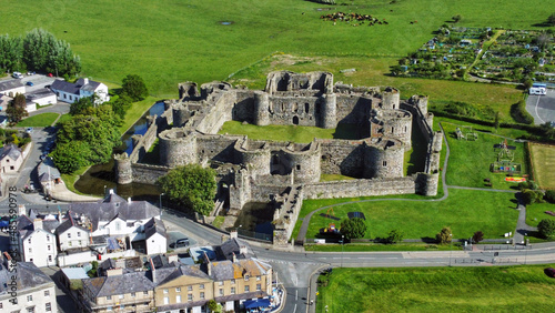 An aerial shot of the ancient Beaumaris castle in Wales surrounded by green field photo